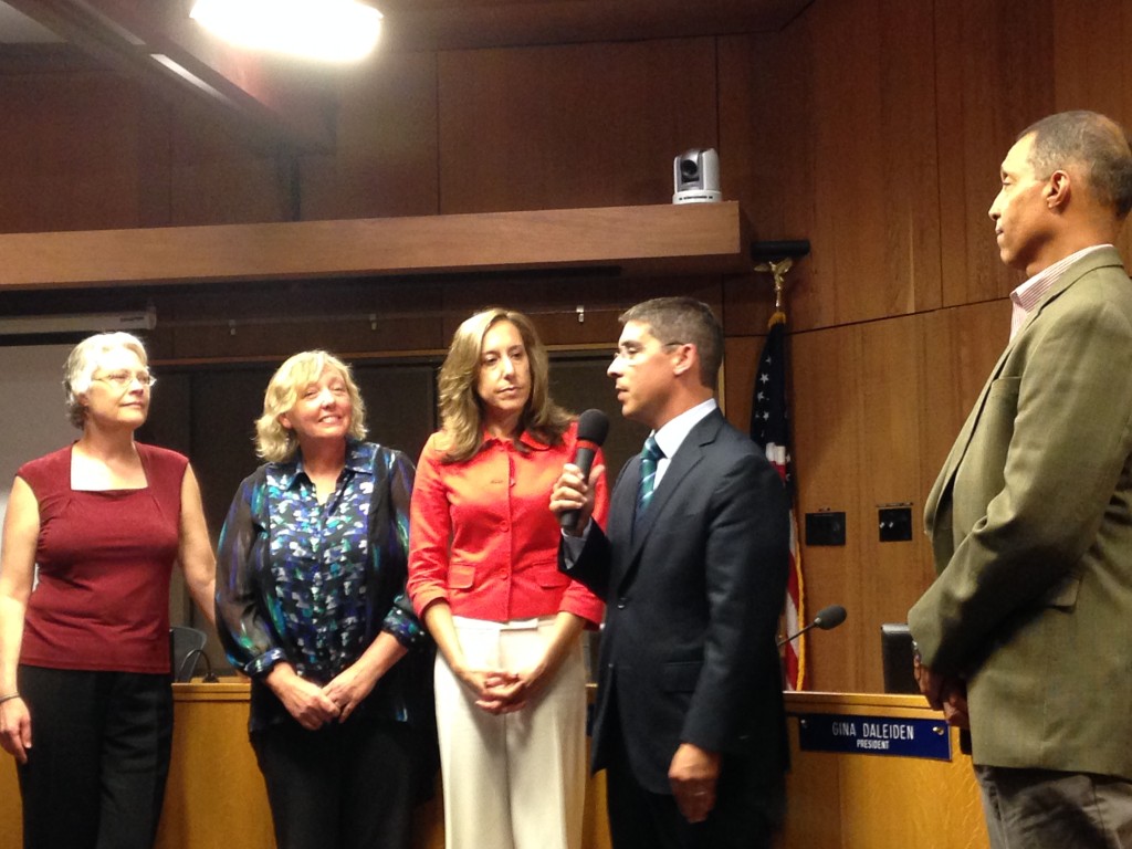 Alan Fernandes speaks after being sworn in surrounded by his new colleagues - Tim Taylor (right) and Gina Daleiden, Sheila Allen, and Susan Lovenburg from right to left.