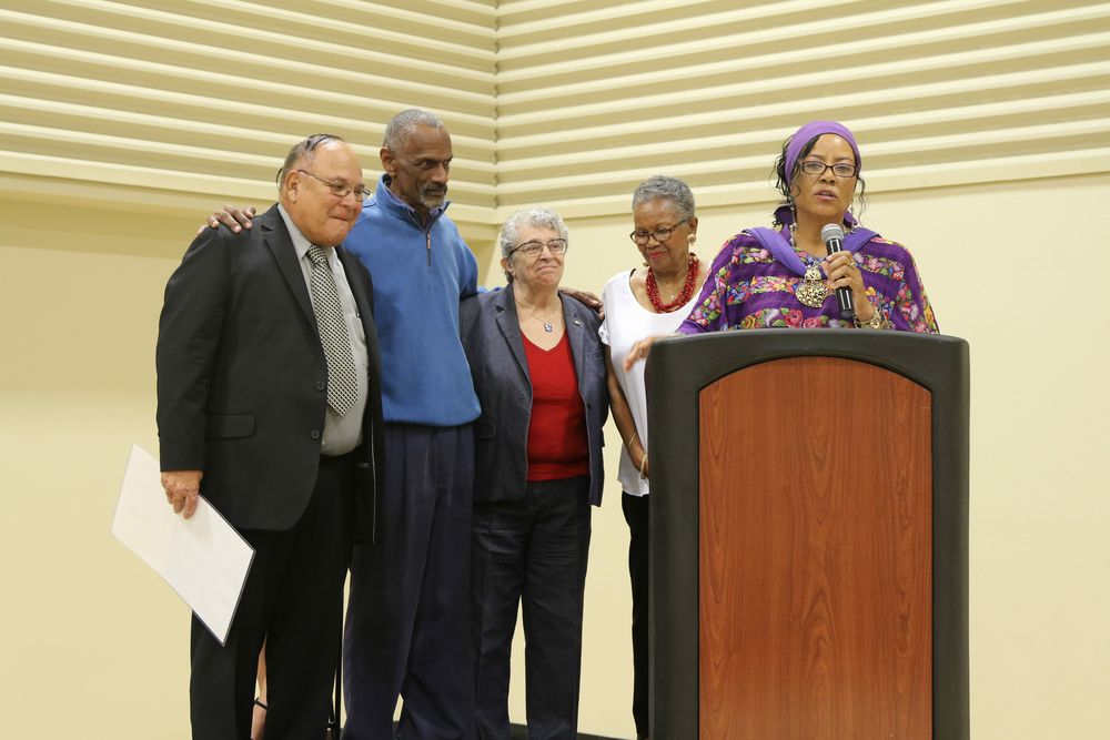 Sandy Holman invites a group of "elders" whose shoulders she stood