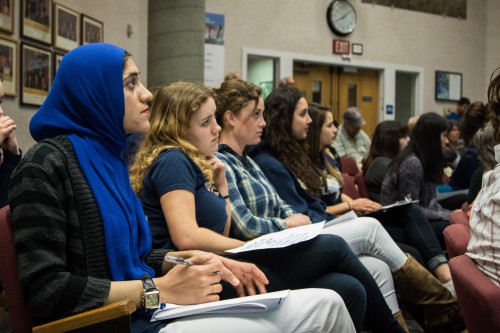 Students listen to public comments at Tuesday's meeting