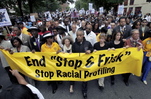 FILE - In this Sunday, June 17, 2012 file photo, Rev. Al Sharpton, center, walks with thousands along Fifth Avenue, during a silent march to end the "stop-and-frisk" program in New York. A federal trial is scheduled to begin in New York on Monday, March 18, 2013, where the NYPDs practice of stopping, questioning and frisking people on the street will face a sweeping legal challenge. The outcome could bring major changes to the nation's largest police force and could affect how other departments use the stop and frisk tactic. (AP Photo/Seth Wenig, File)